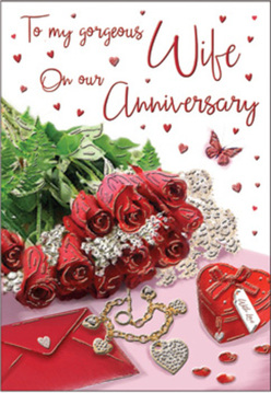 This anniversary card design feels like a treasured keepsake arranged on a windowsill overlooking Petts Wood's quiet gardens, its every detail whispering of long-standing affection. At the centre, a posy of crimson red roses spills gently across the scene, each rosehead generously open and richly coloured, the petals curling in elegant swirls that catch faint highlights of daylight. Lush green foliage peeks between the blooms, giving depth and the impression of freshly cut stems still cool from the morning air. Resting alongside the flowers is a vivid scarlet jewellery box finished with a graceful ribbon, its plush surface suggesting a hidden ring or necklace chosen with care. Nearby, a golden necklace shaped as intertwined hearts is carefully placed, its polished metal reflecting soft glimmers of light, symbolising two lives woven together. The background of the card is scattered with tiny red hearts and sparkling accents, adding a sense of playful romance, while the lovingly scripted message floats across the design, guiding the eye like a personal love letter. Everything is bathed in warm, inviting light, giving the impression of an intimate still life created just before an anniversary dinner in a cosy Petts Wood home. The overall mood is deeply romantic yet calm, a quiet tribute to shared memories, future promises, and the kind of enduring devotion that local couples celebrate year after year.