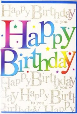 This birthday card presents itself like a little party on paper, the sort of joyful design you might pick up from a friendly high-street shop in Petts Wood before heading to a family gathering. Dominating the front is the phrase "Happy Birthday", printed in large, rounded letters that flow across the card in a smooth rainbow gradient. Each letter carries its own colour-deep berry reds, juicy pinks, lavender purples, crisp aquas, teal and forest greens, then warm ambers and sunshine yellows-blending into each other with the softness of watercolour rather than harsh blocks. The finish looks silky and slightly glossy, as though it would feel pleasantly smooth beneath your fingertips. Behind this striking headline, the background is quietly alive with repeated lines of "Happy Birthday to you" in an elegant, looping gold script. The writing is small and continuous, filling the space like a gentle hum of voices at a birthday tea in a Petts Wood garden, never distracting from the main message but enriching it. Under a lamp or daylight, the gold catches and reflects, giving the impression of fine glitter or metallic foil woven discreetly into the card. Little hints of tiny stars or specks of colour peek between strokes of lettering, adding to the feeling of sprinkled confetti and candles about to be lit. The composition feels thoughtfully balanced: bold, youthful type on top, and a refined, glimmering background underneath. This is the kind of card that would sit proudly next to a vase of bright birthday flowers on a windowsill overlooking the tree-lined streets around Station Square, radiating celebration every time someone walks past.