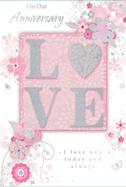 This anniversary card evokes the feeling of an intimate celebration at home in Petts Wood, with its soft, ethereal palette of blush pinks, pearly whites, and whispery greys. Dominating the design, the word "LOVE" is printed in bold, raised letters, each stroke dusted with fine, silver-toned glitter that gives a tactile, almost velvety texture under the fingertips. The letters rest on a gently glowing pink ground, like petals laid against a silk-lined box. Surrounding this focal word, an array of elegantly illustrated flowers and trailing leaves unfurls in curving, rhythmic lines. The blooms feel stylised yet tender, their pale pink and white tones blending with hints of silver, reminiscent of the refined arrangements you might see carried home from a local Petts Wood florist after an evening stroll by the station. The floral pattern drifts outwards in airy swirls, echoing the way a bouquet naturally spills and softens at the edges. Everything is softly lit, as though captured in late-afternoon light, with the glitter catching just enough sparkle to suggest celebration without overwhelming the eye. Fine script lettering delivers anniversary sentiments in an understated, flowing style, balancing the more graphic "LOVE" at the centre. The overall impression is one of quiet romance and long-earned trust - a card that feels as personal and thoughtful as choosing a mix of blush roses and delicate foliage for delivery to a loved one across Petts Wood. It suggests commitment that has grown gently over the years, treasured like a well-cared-for garden in full, gentle bloom.